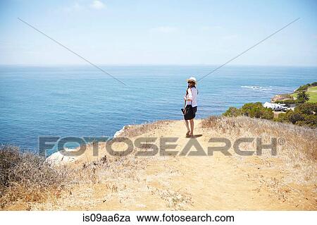 Stock Image - Young woman strolling at coast Palos Verdes, California, USA. Fotosearch