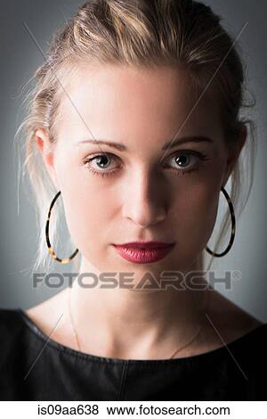 Young woman wearing hoop earrings, portrait View Large Photo Image Stock Photo - Young woman wearing hoop earrings, portrait. Fotosearch