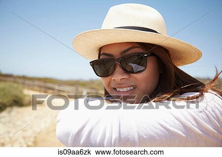 Stock Image - Young woman wearing sunglasses, Palos Verdes, California, USA. Fotosearch
