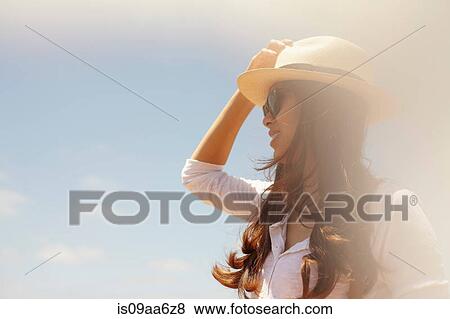 Young woman wearing sunhat and sunglasses View Large Photo Image Stock Photo - Young woman wearing sunhat and sunglasses. Fotosearch