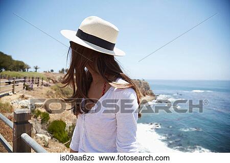Stock Image - Young woman wearing sunhat, Palos Verdes, California, USA. Fotosearch
