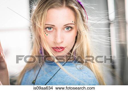 Picture - Young woman with windswept hair, portrait. Fotosearch