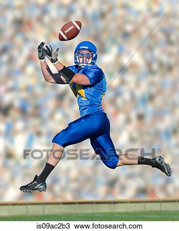 American footballer catching ball View Large Photo Image Stock Image - American footballer catching ball. Fotosearch
