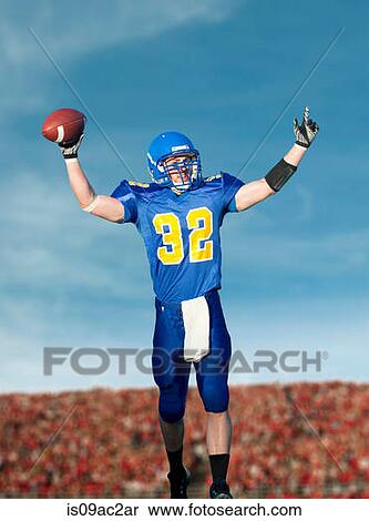 American footballer holding ball View Large Photo Image Stock Photography - American footballer holding ball. Fotosearch