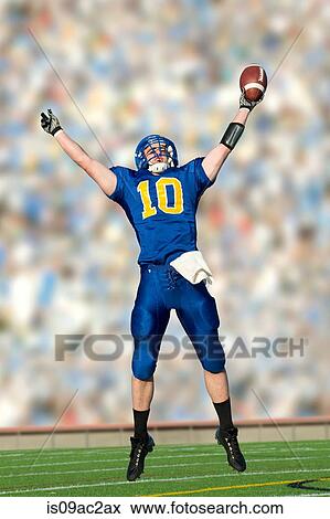 American footballer jumping with ball View Large Photo Image Stock Photo - American footballer jumping with ball. Fotosearch