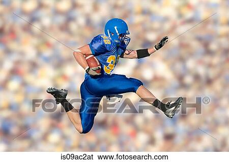 Stock Photograph - American footballer jumping with ball. Fotosearch