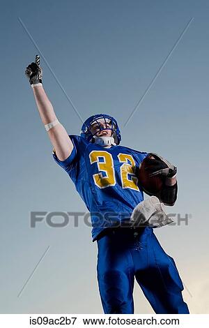 American footballer pointing towards sky View Large Photo Image Stock Photo - American footballer pointing towards sky. Fotosearch