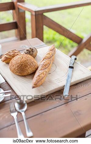 Stock Photo - Assorted breads on board. Fotosearch