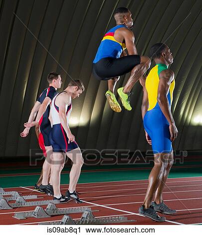 Stock Image - Athletes preparing to start race. Fotosearch