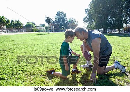Boy and grandfather head to head, man holding football View Large Photo Image Stock Image - Boy and grandfather head to head, man holding football. Fotosearch