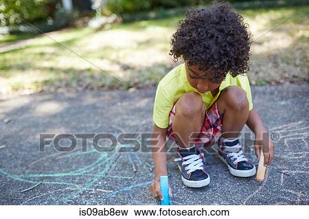 Boy drawing with chalk on sidewalk View Large Photo Image Stock Photo - Boy drawing with chalk on sidewalk. Fotosearch