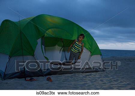 Boy in tent on Huntington Beach, California, USA View Large Photo Image Stock Photo - Boy in tent on Huntington Beach, California, USA. Fotosearch