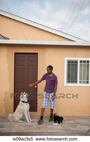 Boy outside house with two dogs View Large Photo Image Stock Photography - Boy outside house with two dogs. Fotosearch