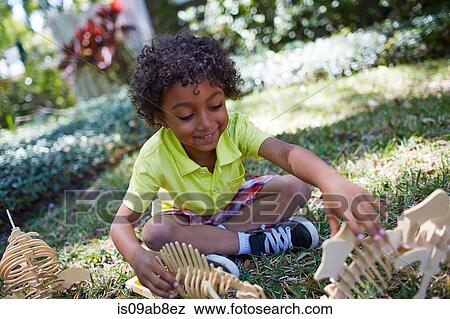 Boy playing with dinosaur skeleton toys View Large Photo Image Stock Photo - Boy playing with dinosaur skeleton toys. Fotosearch