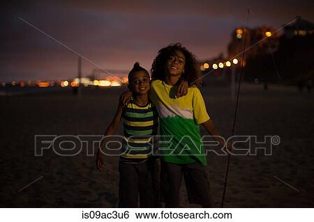 Brothers on beach at night, Huntington Beach, California, USA View Large Photo Image Stock Photograph - Brothers on beach at night, Huntington Beach, California, USA. Fotosearch