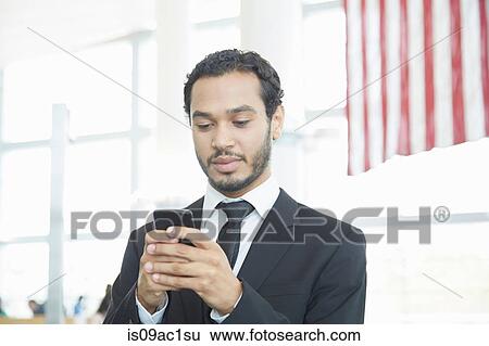Stock Photograph - Businessman using smartphone. Fotosearch