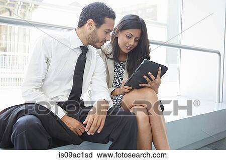 Stock Image - Businesspeople using digital tablet. Fotosearch