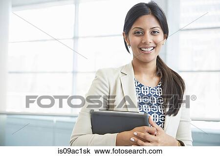 Businesswoman holding digital tablet View Large Photo Image Stock Image - Businesswoman holding digital tablet. Fotosearch