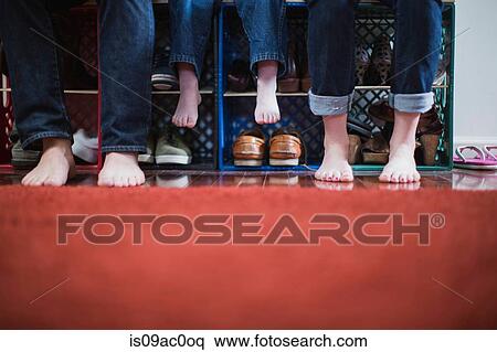 Stock Photography - Child and parents with bare feet, low section. Fotosearch