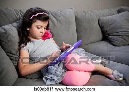 Stock Image - Child using digital tablet. Fotosearch