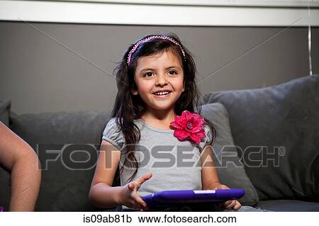 Child with digital tablet on sofa View Large Photo Image Stock Image - Child with digital tablet on sofa. Fotosearch
