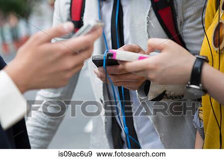 Stock Photo - Close up of hands holding mp3 player. Fotosearch