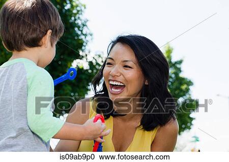 Stock Image - Close up of mother and male toddler in park. Fotosearch