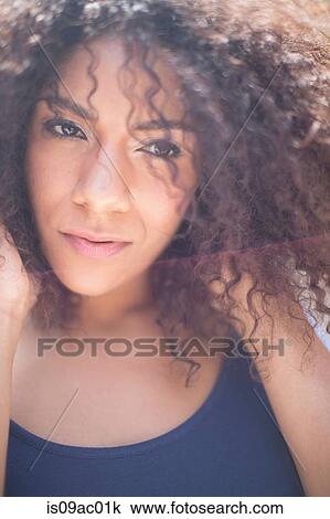 Stock Image - Close up of young woman with curly air. Fotosearch
