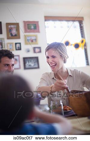 Stock Photo - Family at meal time. Fotosearch