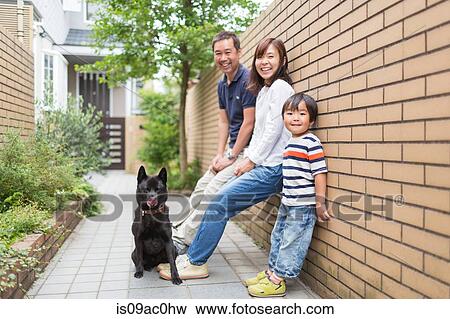 Family outdoors with pet dog View Large Photo Image Stock Photo - Family outdoors with pet dog. Fotosearch