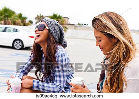 Female friends sitting in car lot, Hermosa Beach, California, USA View Large Photo Image Stock Photography - Female friends sitting in car lot, Hermosa Beach, California, USA. Fotosearch