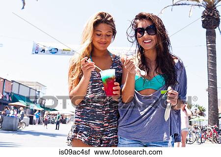 Stock Image - Female friends with iced drink, Hermosa Beach, California, USA. Fotosearch