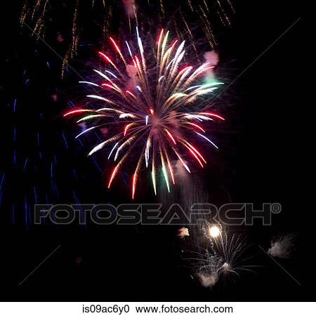 Stock Image - Fireworks exploding in night sky. Fotosearch