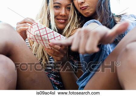 Friends eating takeaway food, Hermosa Beach, California, USA View Large Photo Image Stock Image - Friends eating takeaway food, Hermosa Beach, California, USA. Fotosearch