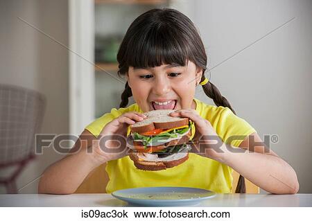 Girl biting into sandwich View Large Photo Image Stock Image - Girl biting into sandwich. Fotosearch