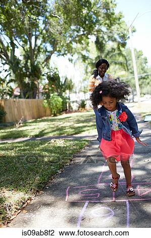 Girl doing hopscotch View Large Photo Image Stock Image - Girl doing hopscotch. Fotosearch