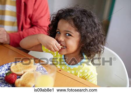 Girl having breakfast View Large Photo Image Stock Image - Girl having breakfast. Fotosearch
