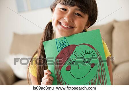 Stock Photograph - Girl holding picture of face. Fotosearch