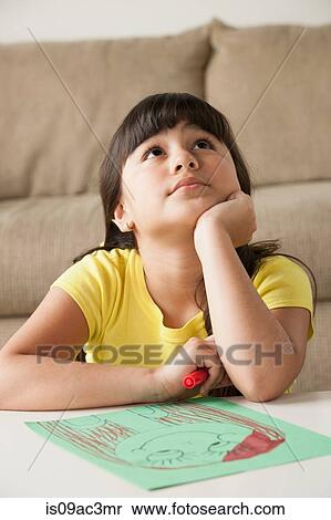 Girl looking up, drawing on table View Large Photo Image Stock Photography - Girl looking up, drawing on table. Fotosearch