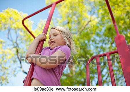Stock Image - Girl on climbing frame. Fotosearch