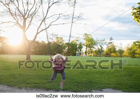 Girl on swing View Large Photo Image Stock Photo - Girl on swing. Fotosearch