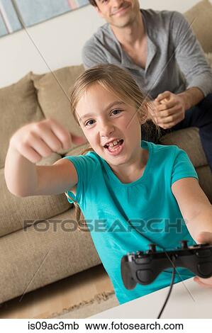 Girl playing video game View Large Photo Image Stock Image - Girl playing video game. Fotosearch