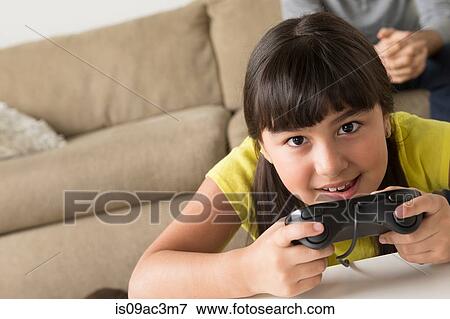 Stock Photo - Girl playing video game. Fotosearch