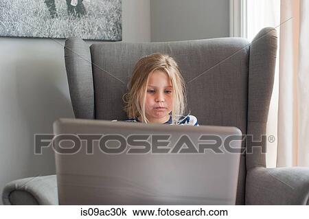 Stock Image - Girl using laptop. Fotosearch