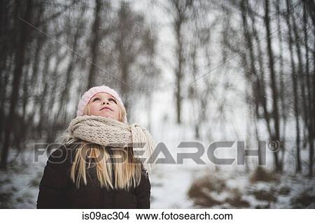 Girl wearing hat and scarf looking up in winter View Large Photo Image Picture - Girl wearing hat and scarf looking up in winter. Fotosearch