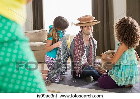 Stock Photograph - Girls dressing up father. Fotosearch