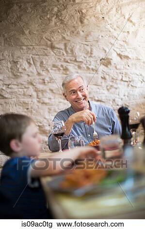 Grandfather and grandson at meal time View Large Photo Image Stock Image - Grandfather and grandson at meal time. Fotosearch