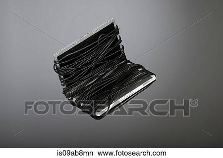 Laptop covered in power cable View Large Photo Image Picture - Laptop covered in power cable. Fotosearch