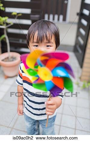 Little boy with a pinwheel View Large Photo Image Stock Image - Little boy with a pinwheel. Fotosearch