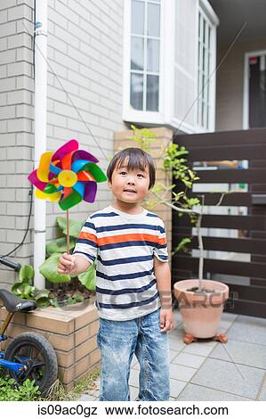 Little boy with a pinwheel View Large Photo Image Stock Photo - Little boy with a pinwheel. Fotosearch